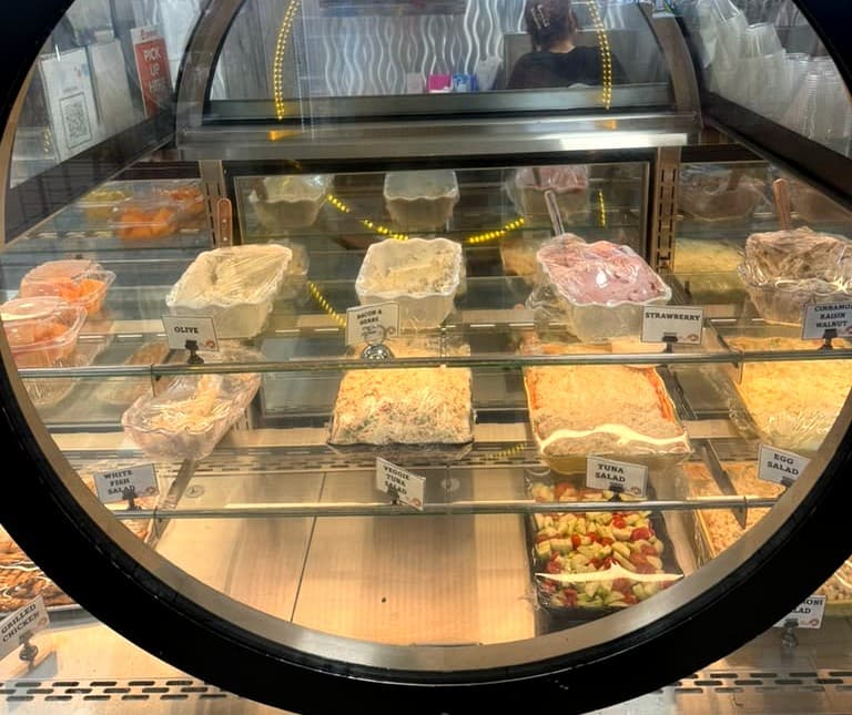 Olive, tuna, egg salad, and strawberry cream cheese in the case